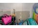 A cluttered storage area with a pink tote bag and other miscellaneous household items at 1500 Sunset Rd # G4, Tarpon Springs, FL 34689