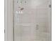 Modern walk-in shower with seamless glass door and bright, neutral tile surround at 15635 Sacile Ln, Bradenton, FL 34211