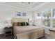 Bright bedroom with large window, tray ceiling, and neutral decor at 15635 Sacile Ln, Bradenton, FL 34211