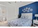 Comfortable bedroom featuring a blue accent wall and access to an ensuite bathroom at 15635 Sacile Ln, Bradenton, FL 34211