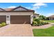 A two-car garage with a paved driveway and manicured front yard at 15635 Sacile Ln, Bradenton, FL 34211