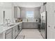 Kitchen features stainless steel appliances, white cabinets and countertops, and tile backsplash at 15635 Sacile Ln, Bradenton, FL 34211