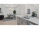 Open floor plan with bright kitchen overlooking a dining area and modern chandelier at 15635 Sacile Ln, Bradenton, FL 34211