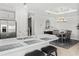 Bright kitchen with stainless steel appliances, island, and dining area with modern chandelier at 15635 Sacile Ln, Bradenton, FL 34211