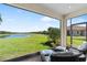 Screened lanai with comfortable seating and views of the lake at 15635 Sacile Ln, Bradenton, FL 34211