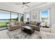 Inviting living room with lake views, tray ceiling, and ample seating at 15635 Sacile Ln, Bradenton, FL 34211
