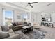 Open-concept living space with modern furniture and accents plus a view of the bar and kitchen at 15635 Sacile Ln, Bradenton, FL 34211