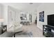 Open-concept floor plan featuring stylish furniture, neutral tones, and seamless flow to kitchen and bar at 15635 Sacile Ln, Bradenton, FL 34211