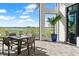 Covered patio seating overlooking the lush green golf course and serene lake at 15635 Sacile Ln, Bradenton, FL 34211