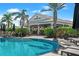 Poolside view of the Bahama Bar, lounge chairs, and palm trees, creating a tropical relaxation spot at 15635 Sacile Ln, Bradenton, FL 34211