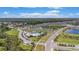 Community aerial showcasing a beautiful pool, clubhouse, playgrounds, dog park, ponds, and lush landscaping at 18184 Turning Leaf Cir, Land O Lakes, FL 34638