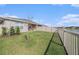 Well-maintained backyard with lawn, patio, and peaceful water view behind the fence at 18184 Turning Leaf Cir, Land O Lakes, FL 34638