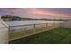 Backyard features a white fence and a serene view of a lake and neighboring homes at 18184 Turning Leaf Cir, Land O Lakes, FL 34638