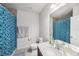Bathroom with a single sink, tile flooring, and a shower with blue tile accents at 18184 Turning Leaf Cir, Land O Lakes, FL 34638