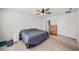 Bright bedroom with a ceiling fan, closet, a wood dresser, and neutral carpet at 18184 Turning Leaf Cir, Land O Lakes, FL 34638