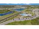 Aerial view of community pool, playground, parking, and serene lakes surrounded by homes at 18184 Turning Leaf Cir, Land O Lakes, FL 34638
