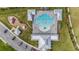 Overhead view showcasing the community pool, clubhouse, playground, and parking lot at 18184 Turning Leaf Cir, Land O Lakes, FL 34638