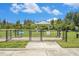 Fenced entrance to community dog park with green space at 18184 Turning Leaf Cir, Land O Lakes, FL 34638
