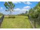 Fenced dog park with trees, a gazebo, and a bench offers a secure space for pets to exercise and socialize at 18184 Turning Leaf Cir, Land O Lakes, FL 34638