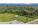 Aerial view of fenced dog park with shaded shelter and benches at 18184 Turning Leaf Cir, Land O Lakes, FL 34638