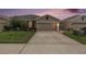 Charming single Gathering home exterior featuring manicured lawn and attached two car garage at 18184 Turning Leaf Cir, Land O Lakes, FL 34638