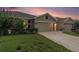 Charming single Gathering home exterior featuring manicured lawn and attached two car garage at 18184 Turning Leaf Cir, Land O Lakes, FL 34638