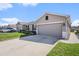 Charming single-story home with a well-manicured lawn and attached two-car garage at 18184 Turning Leaf Cir, Land O Lakes, FL 34638
