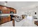 Open concept kitchen with black appliances, granite countertops, and an island with sink at 18184 Turning Leaf Cir, Land O Lakes, FL 34638