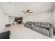 Open-concept living room and kitchen with modern tile flooring and a comfortable gray sofa at 18184 Turning Leaf Cir, Land O Lakes, FL 34638