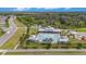Aerial view of the community pool and recreation area with a splash pad, tables, and playground equipment at 18184 Turning Leaf Cir, Land O Lakes, FL 34638