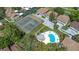 Aerial view of community showing the pool, tennis courts, parking and surrounding condo buildings at 1830 Bough Ave # 2, Clearwater, FL 33760