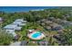Aerial view showcasing the community pool, clubhouse, and proximity to the waterfront and natural surroundings at 1830 Bough Ave # 2, Clearwater, FL 33760