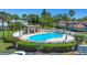 Inviting community pool area with ample seating, shade, and well-maintained landscaping for outdoor enjoyment at 1830 Bough Ave # 2, Clearwater, FL 33760