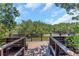 Tranquil dock view over a canal, featuring surrounding green mangrove trees under a sunny blue sky at 1830 Bough Ave # 2, Clearwater, FL 33760
