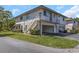 Two-story condo building featuring private balconies, covered parking, and well-manicured lawns at 1830 Bough Ave # 2, Clearwater, FL 33760
