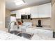 Bright kitchen featuring white cabinets, a stainless steel microwave, and stylish granite countertops at 1830 Bough Ave # 2, Clearwater, FL 33760