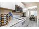 Well-lit kitchen features white cabinets, granite countertops, and stainless steel microwave at 1830 Bough Ave # 2, Clearwater, FL 33760