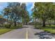 Picturesque street view lined with mature trees and well-maintained lawns, highlighting a serene neighborhood setting at 1830 Bough Ave # 2, Clearwater, FL 33760