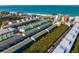 Expansive aerial shot of the property with beach access nearby and green landscaping at 19823 Gulf Blvd # 33, Indian Shores, FL 33785