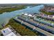Aerial view of a waterfront condo community with lush green landscaping and beautiful water views at 19823 Gulf Blvd # 33, Indian Shores, FL 33785