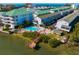 Aerial view of waterfront condos, pool, and private dock access to the water at 19823 Gulf Blvd # 33, Indian Shores, FL 33785