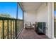 Cozy outdoor balcony, features tiled flooring and two chairs with mini refrigerator at 19823 Gulf Blvd # 33, Indian Shores, FL 33785