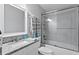 Modern bathroom with granite countertop, sliding glass shower doors and tiled shower at 19823 Gulf Blvd # 33, Indian Shores, FL 33785