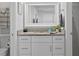 Bright bathroom vanity features granite countertop and white cabinets at 19823 Gulf Blvd # 33, Indian Shores, FL 33785