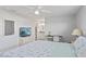 Inviting bedroom with ceiling fan, a full size bed, and adjacent ensuite bathroom at 19823 Gulf Blvd # 33, Indian Shores, FL 33785