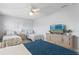 Comfortable bedroom features two twin beds and one full-sized bed with a television at 19823 Gulf Blvd # 33, Indian Shores, FL 33785