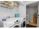 Functional laundry room with modern appliances, ample storage shelves, and easy access to stairs at 19823 Gulf Blvd # 33, Indian Shores, FL 33785
