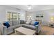 Comfortable living room with a large sectional couch and a screened lanai at 19823 Gulf Blvd # 33, Indian Shores, FL 33785
