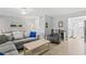 Bright living room features a comfortable gray sectional, wood coffee table and neutral decor at 19823 Gulf Blvd # 33, Indian Shores, FL 33785