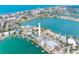 An aerial view showcases the canal-front home with a private dock, pool, and prime location near the beach at 203 Bath Club N Blvd, North Redington Beach, FL 33708
